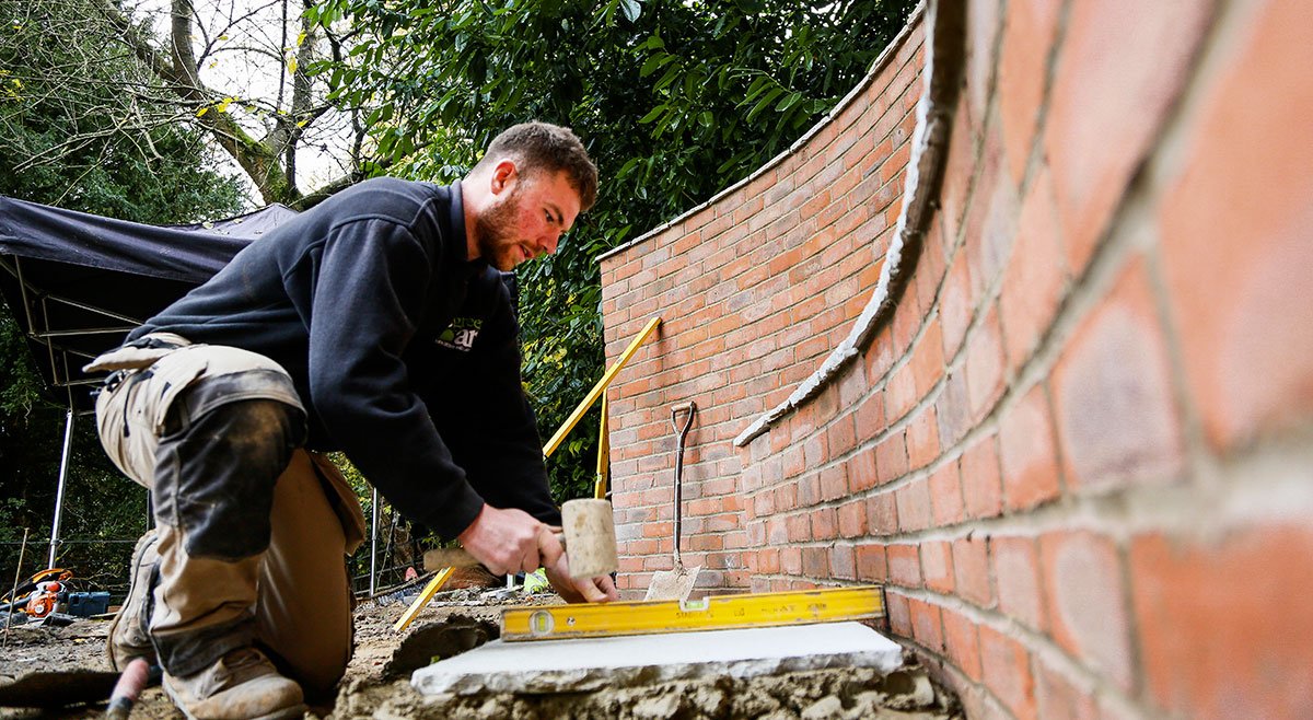 Man building a wall in garden