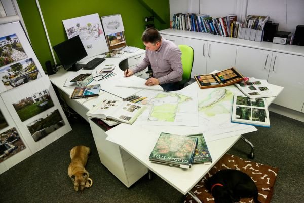 George designing a garden at his desk