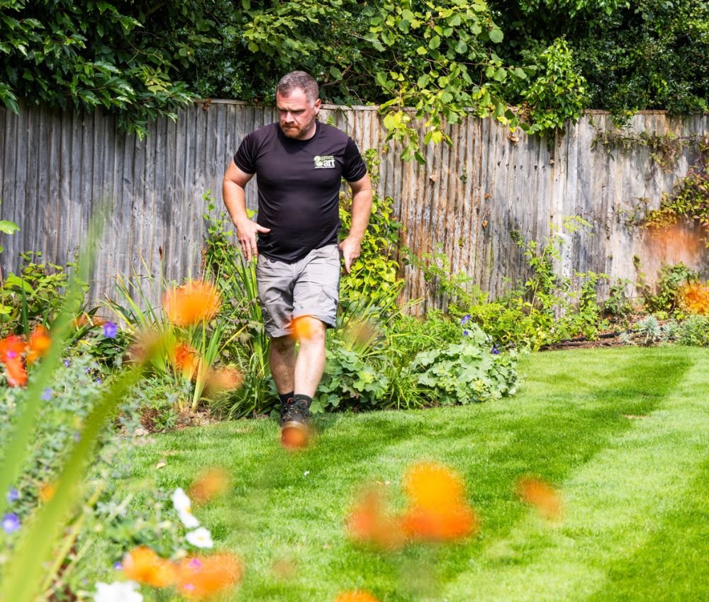 Greenart staff member walking in a maintained garden