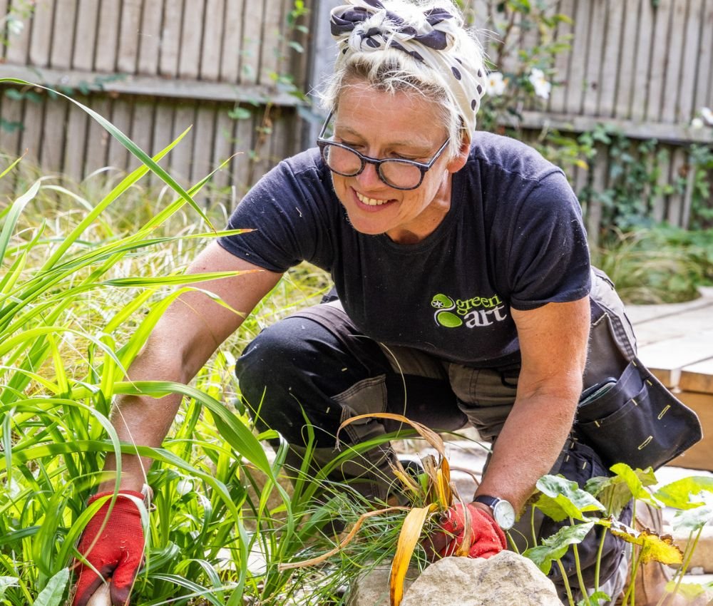 Women gardening with glasses and smiling